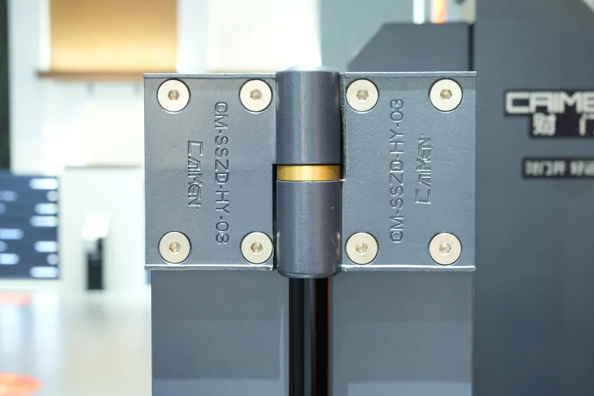 Close view of a CAIMEN gate hinge and mechanical connection on display.