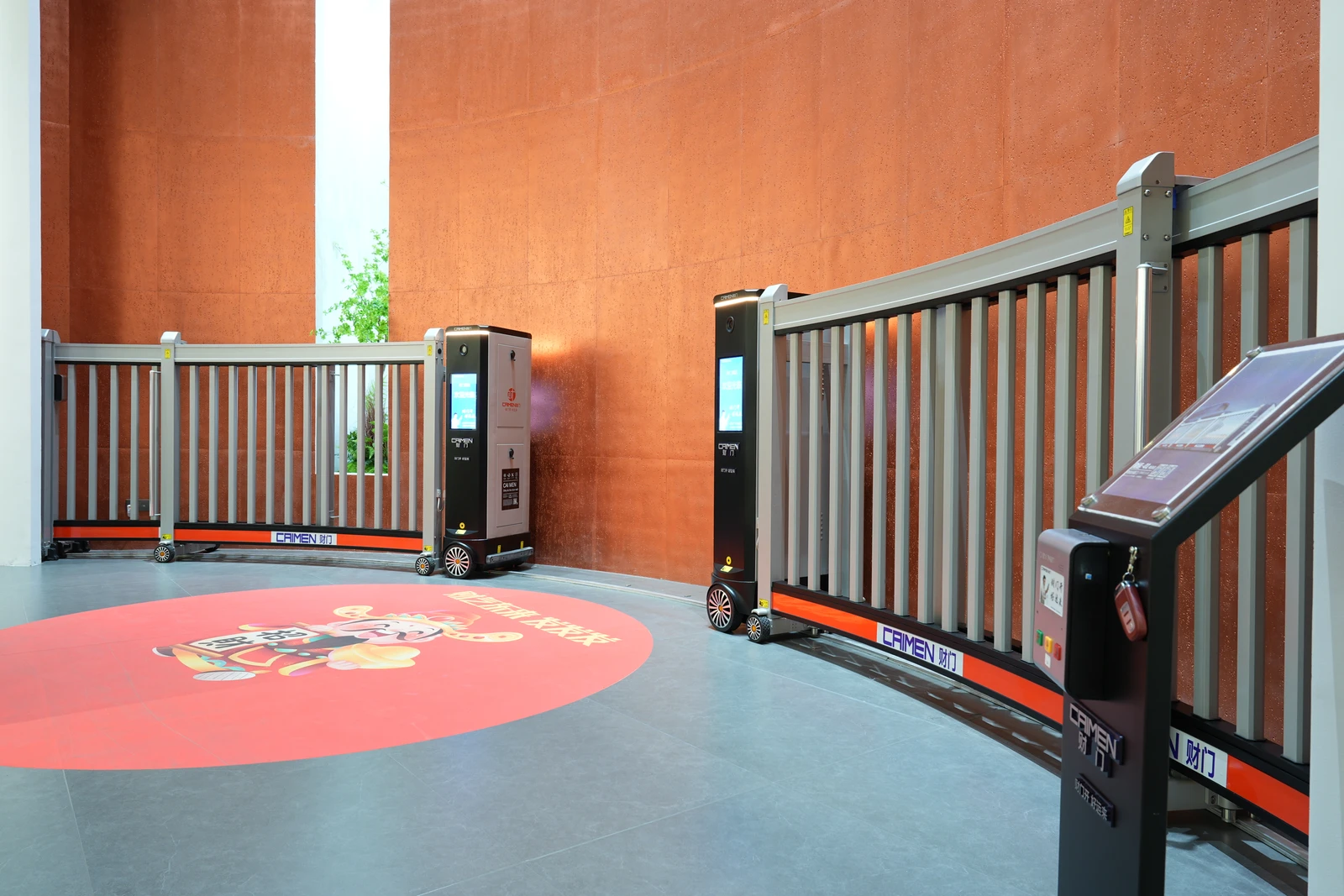 CAIMEN bi-folding gate and entrance control terminal in the showroom.