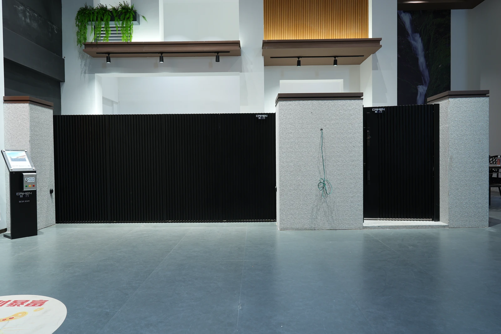 CAIMEN sectional gate panels closed across the showroom opening.