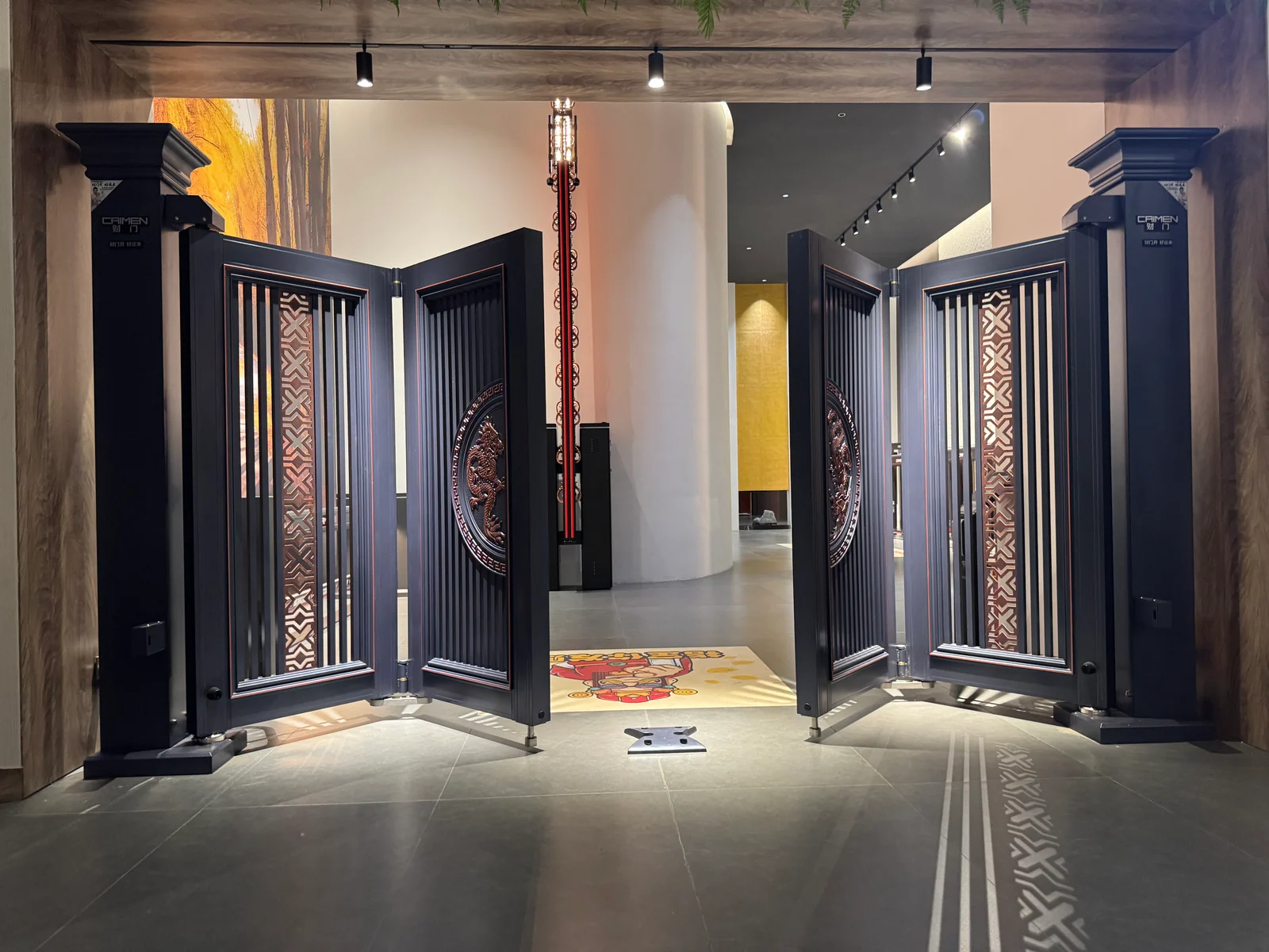 CAIMEN bi-folding gate with both pairs of panels folded in the showroom.