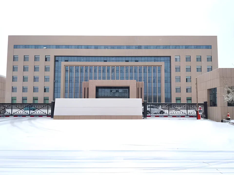 Twin cantilever sliding gates installed at a snowy facility entrance